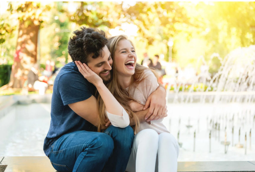 Millennial parents laughing and communicating together.