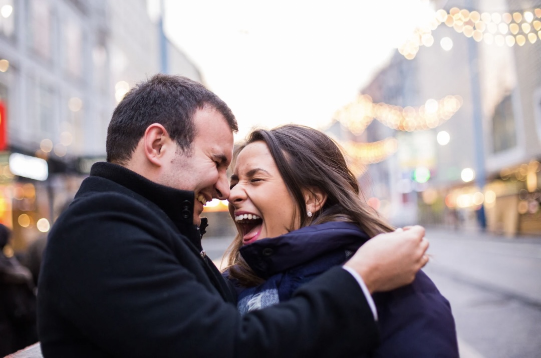 Couple sharing a laugh to rebuild emotional closeness using Gottman Method tools.